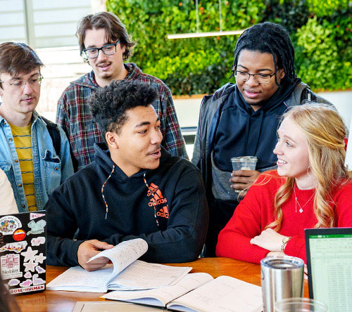 A group of students around a computer