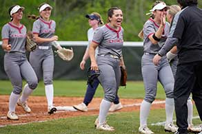 Image shows softball player getting ready to hit the ball.