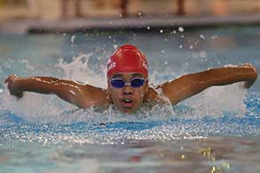 Swimmers racing in the pool.