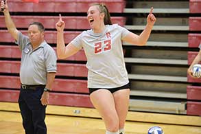 Volleyball team circling up before a game.