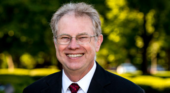 A smiling Dr. Richard Ditteon standing outdoors on the Rose-Hulman campus