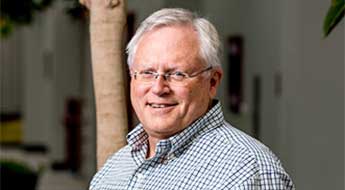 Don Richards smiling and standing outdoors on the Rose-Hulman campus.