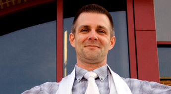 A smiling Dr. James Hanson standing outdoors on the Rose-Hulman campus.