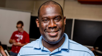 A smiling Professors John Aidoo in a Rose-Hulman lab.