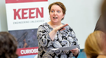  Image shows a  professor working with a student in a Rose-Hulman classroom.