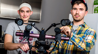 Two students conduct research inside a biomedical engineering laboratory.