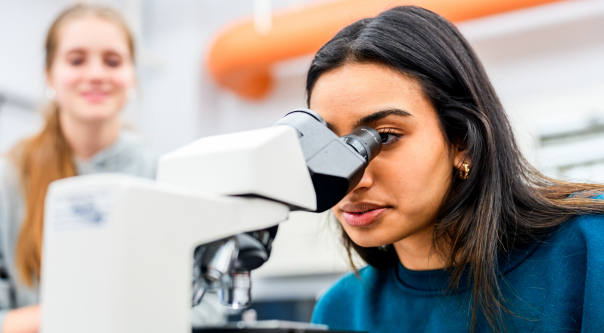 Two students work together in a biology laboratory. 