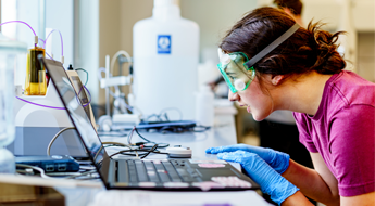 One female student checking equipment during an experiment.