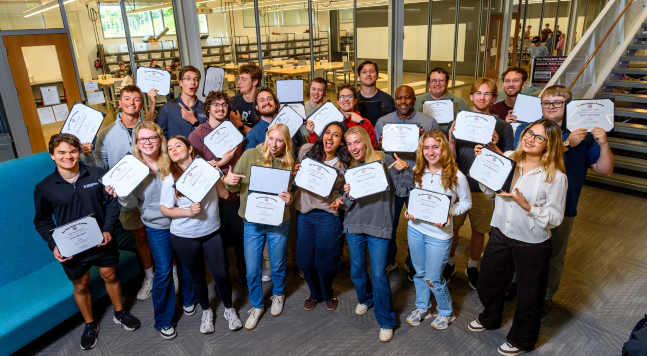Graduate students receiving a seminar certificate. 