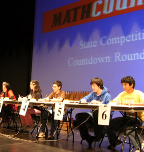 Students sitting at a table during the ' countdown round' of the state MATHCOUNTS competition.
