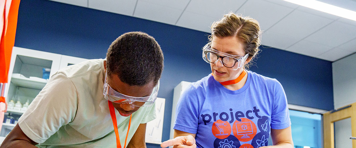 Student and faculty working in class.