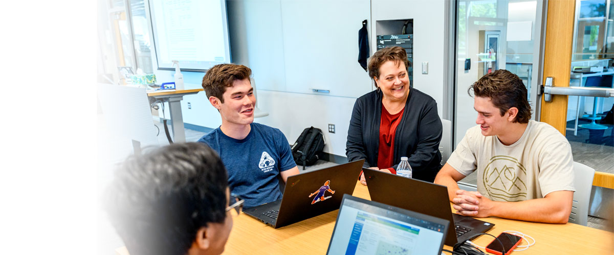 Students and faculty working in a classroom.