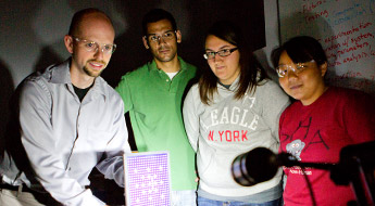  Engineering director Scott Small works with a group of students