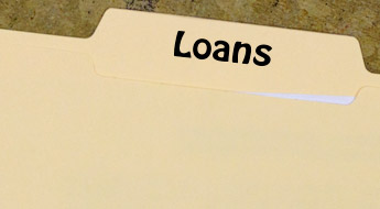 Image shows a manila folder containing a sheet of paper. The folder is labeled Loans.