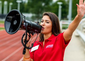 Female in RHIT shirt with a bullhorn