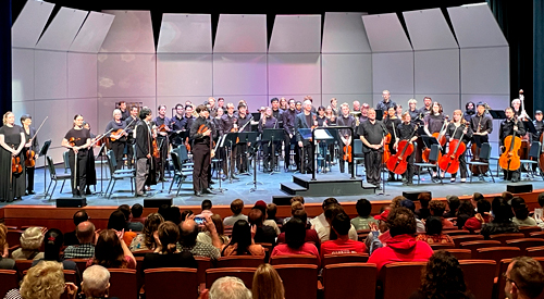 Students performing on musical instruments on stage