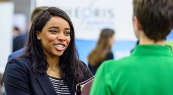 Student talking with company representative.