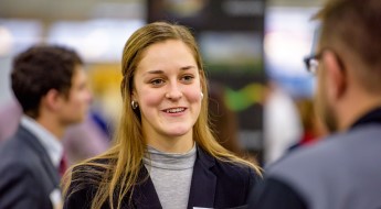 Student talking with company representative.