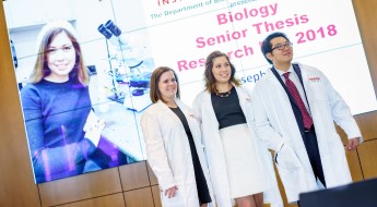 Three biology students at their thesis presentations.