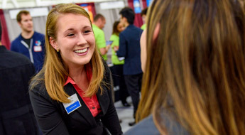Female student meets with recruiter at Career Fair.