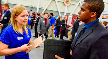 Female recruiter talks to male student