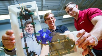 Four students holding a project
