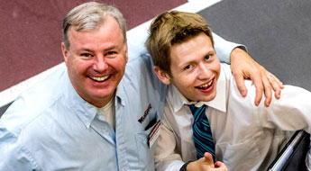 Parent with arm around son attending career fair