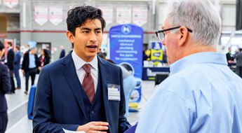 Female recruiter talks to male student