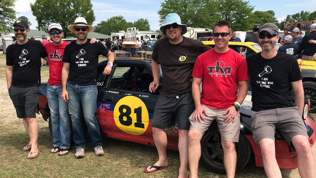 Alexander Yovanovich, Frank Levinson, Cooper Lacy, Michael Gough, Matthew Neisen and Matthew Smith lean against their #81 car.