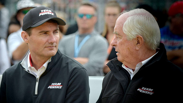 Tim Cindric speaks with a Team Penske colleague.