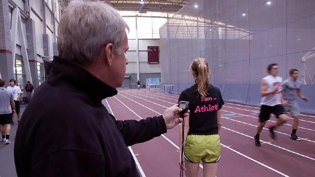 Coach Larry Cole timing athletes in the Sports & Recreation Center.