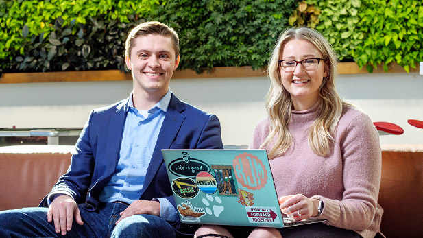 Carson Thrift and Kyla Jarvis sitting on a couch in Mussallem Union.