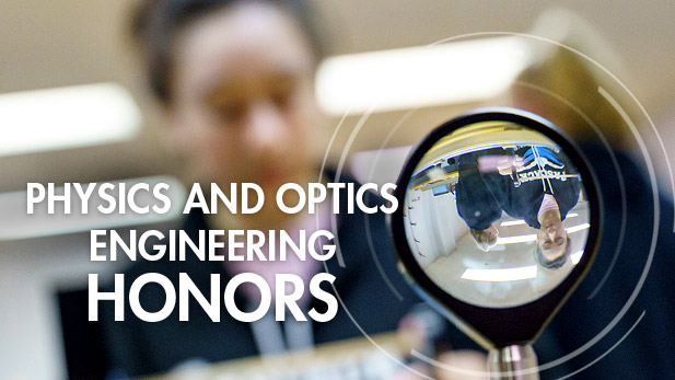 Upside down view of a student through a lens in an optical engineering lab.