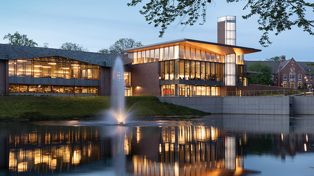 Exterior night view of Mussallem Union and a fountain on Speed Lake.