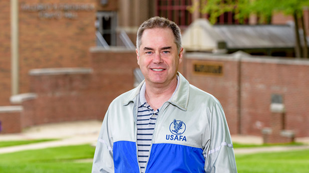 Brad Burchett standing on campus in a United States Air Force Academy jacket.