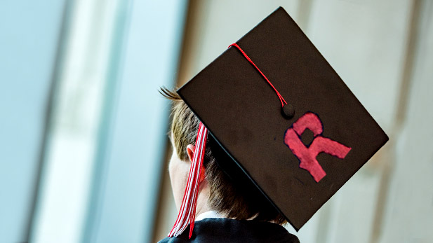 Graduate wearing graduation cap with a Rose-Hulman R in the cap.