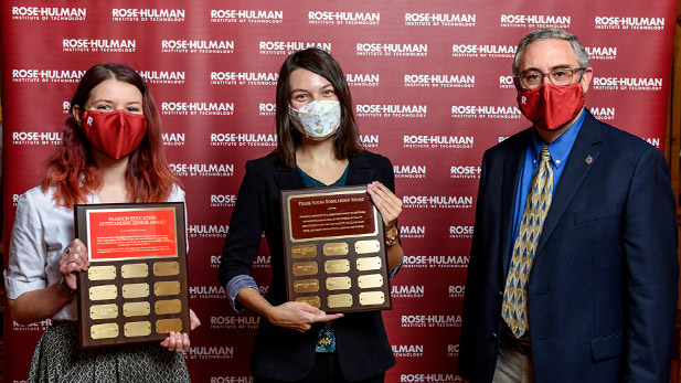 Joanna Garrett and Jessica Myers hold their awards next to J.P. Mellor.