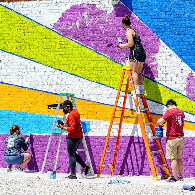 Click to watch video about Noblitt Scholars mural project.