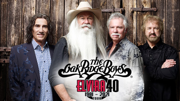 The Oak Ridge Boys in front of a wood wall.