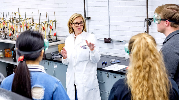 Rose-Hulman Professor of Chemistry Rebecca DeVasher working with students in a lab.