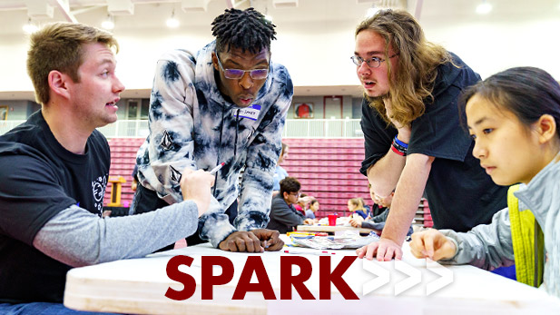 Four students working on a SPARK project together at a table.