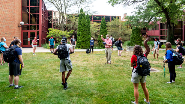 A class meets on the lawn in front of Olin Hall.