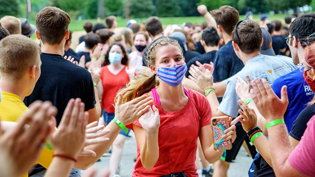 New students run through a crowd of returning students getting high-fives as part of Rose-Hulman's new student orientation.