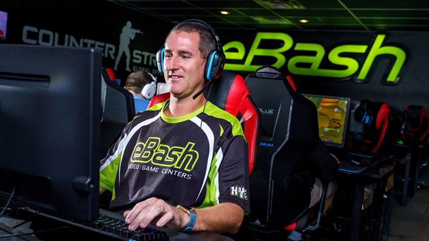 Zack Johnson plays a game on a computer at eBash.