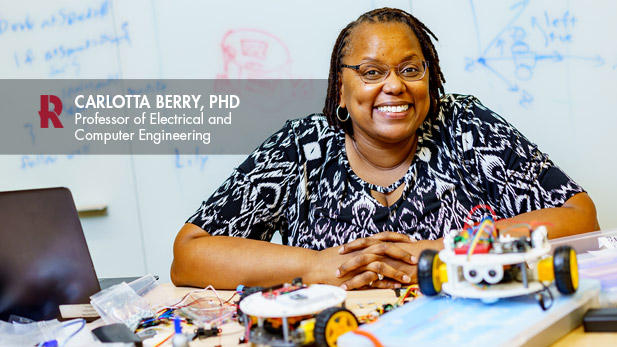 Dr. Carlotta Berry poses with her Lilly Bots.