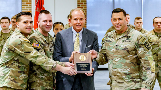 President Rob Coons and members of Rose-Hulman Army ROTC hold the award.