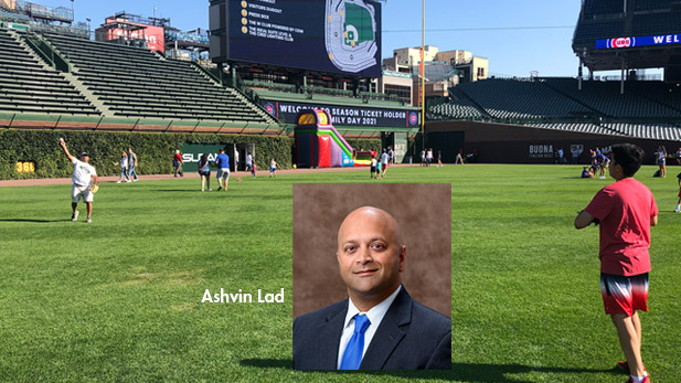 There are two images. Back: Groups play catch at Wrigley Field. Front: Asvin Lad headshot.