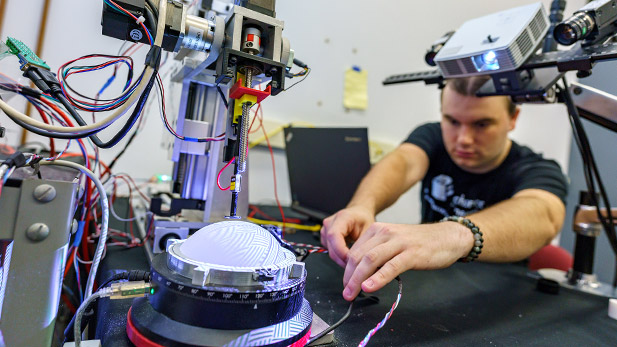 A student works on the robotic device.