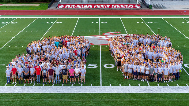 Class of 2026 group photo on the football field forming a 26.