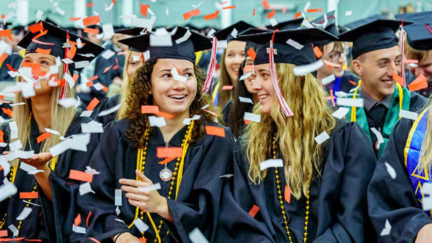 Students smiling at Rose-Hulman's 2022 Commencement as confetti falls.